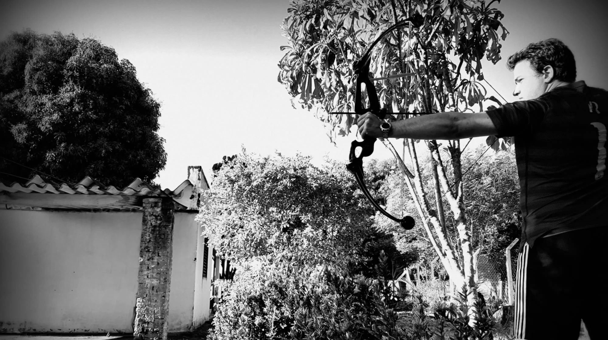 Rodrigo holding a compound bow and an arrow